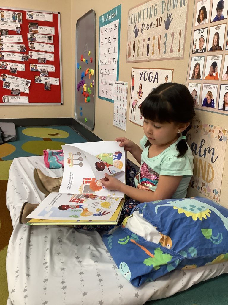 young girl reads a book